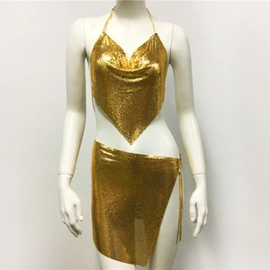 Detail of gold metal sequin two-piece set with V-neck halter top and side slit mini skirt
