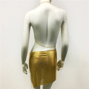 Detail of shimmering gold metal mesh sequin skirt with reflective texture on mannequin