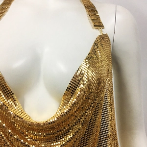 Detail of golden chainmail sequin halter top featuring a deep V-neck and metallic mesh