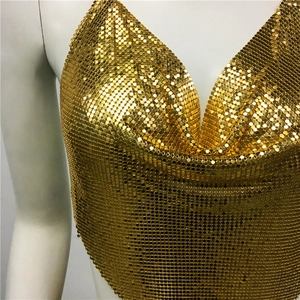 Close-up of golden metal mesh sequin camisole with cowl neck and metallic shimmer