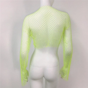 Close-up of neon green fishnet crop top featuring shimmering rhinestones on mesh