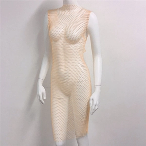 Detail of apricot mesh dress featuring sparkling rhinestones and an elegant high neckline