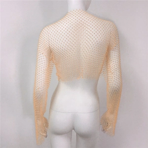 Detail of apricot mesh top featuring fine net texture and shimmering rhinestone accents