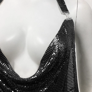 Detail of black sequin halter top featuring a deep V-neck and metallic mesh texture