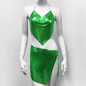 Detail of emerald green metal sequin mesh two-piece set featuring halter top and slit mini skirt