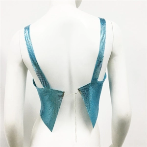 Detail of bright blue metallic sequin mesh top with back metal chain straps