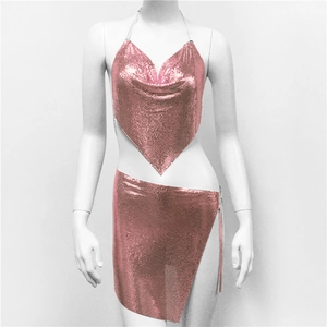Detail of pink metal sequin two-piece set featuring halter top and side slit mini skirt