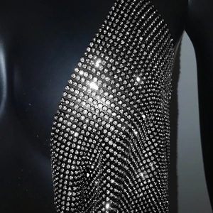 Detailed macro view of silver rhinestone mesh fabric and crystal chain link texture