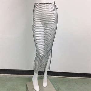 Close-up of black fishnet skirt featuring shimmering rhinestones and a side slit detail