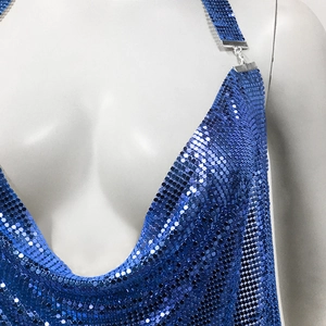 Detailed macro view of shimmering blue metallic sequins and deep V-neckline of the party dress
