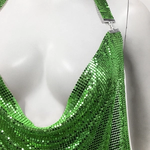 Detail shot of emerald green metal sequin halter top featuring a deep V-neckline