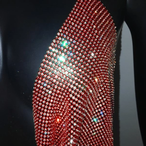 Close-up of red rhinestone mesh fabric with sparkling crystals on a black mannequin
