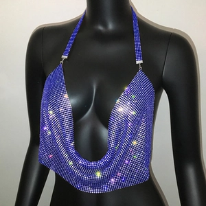 Close-up of blue rhinestone halter neck top with sparkling chain details and sequins