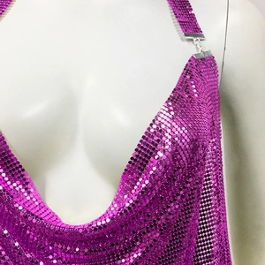 Close-up of deep V-neckline on magenta metallic sequin dress with silver chain straps