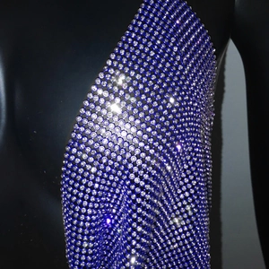Detailed macro view of blue rhinestone mesh metal chain top on black mannequin