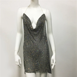 Detail of silver rhinestone mesh dress with deep V-neckline and shimmering metallic texture