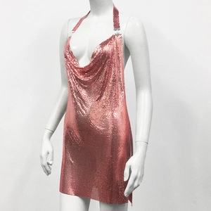 Close-up detail of pink metallic sequins and mesh fabric on a halter cowl neck dress
