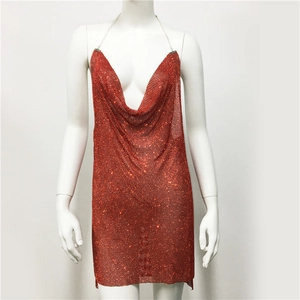 Detail of red sequin chainmail dress showing deep V cowl neck and silver chain straps