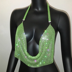 Macro shot of light green rhinestone mesh fabric and deep V-neck detail on a sexy halter top