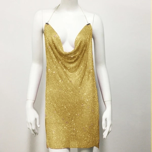 Detail of gold metal mesh dress with deep V-neck and sparkling rhinestone chain straps