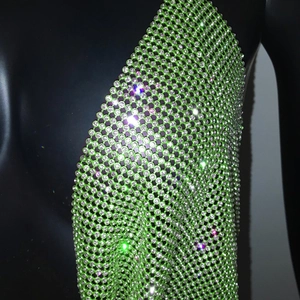 Close-up of green rhinestone mesh crop top with shimmering crystal net texture