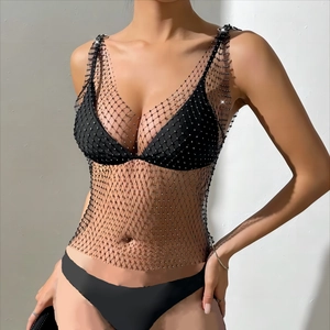 Macro detail of high-shine rhinestones on sexy mesh fishnet top with sparkling crystals