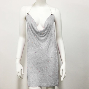 Detailed view of silver sequin mini dress with deep V-neckline and metal mesh texture