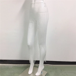 Detail view of white rhinestone mesh skirt with sparkling crystals and high side slit