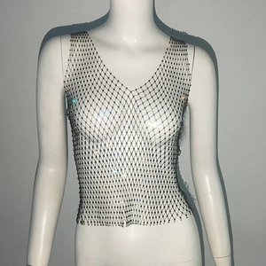 Close-up of sparkling rhinestone mesh top with metallic chain details on a mannequin