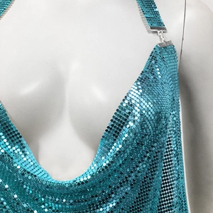 Macro view of metallic turquoise sequin mesh fabric with high-gloss reflective finish