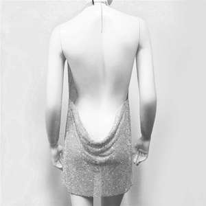 Detailed back view of a silver sequin dress featuring a sexy deep V-back design