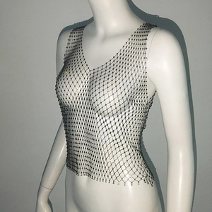 Detailed view of silver rhinestone fishnet crop top showing sparkling mesh texture