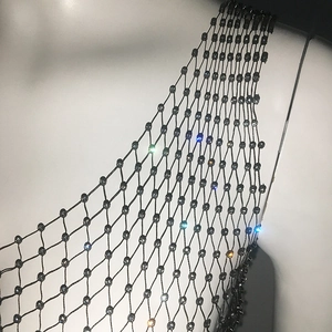 Close-up of black mesh vest fabric with sparkling colorful rhinestones on a mannequin