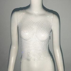 Close-up of white mesh rhinestone vest with shimmering crystals and intricate net texture