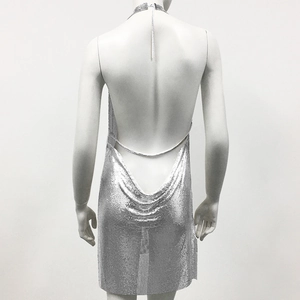 Detail of silver metallic sequin dress featuring an open back and halter neck design
