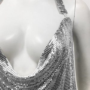 Close-up of silver metal chainmail sequins and deep V-neck halter design on this party top