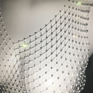 Macro detail of sexy white mesh fishnet top featuring sparkling rhinestone embellishments