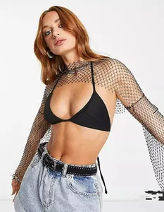 Detailed close-up of a black mesh shrug with shiny beads and a wide knit structure