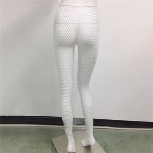 Detailed close-up of white rhinestone fishnet skirt with sparkling crystal embellishments
