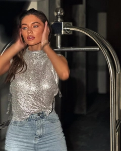 Detail of silver metallic mesh top showing sparkling rhinestones and side fringe accents