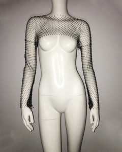 Close-up of black mesh shrug top with sparkling rhinestones and long sleeves
