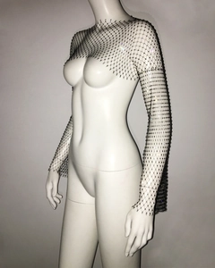 Detail of black rhinestone mesh shrug featuring long sleeves and sparkling crystal accents
