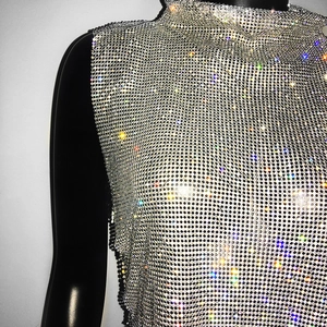 Detail of silver rhinestone mesh fabric and high neck design on backless party top