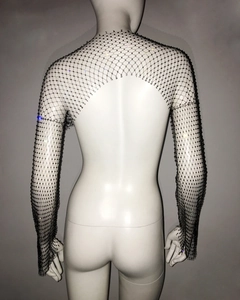 Macro detail of the backless cutout and sparkling rhinestones on the black mesh top