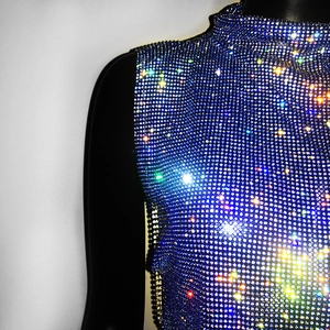 Detail of blue rhinestone sleeveless top featuring sparkling crystals and stand collar