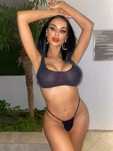 Detail of sexy black bikini with colorful rhinestones and mesh cover-up skirt