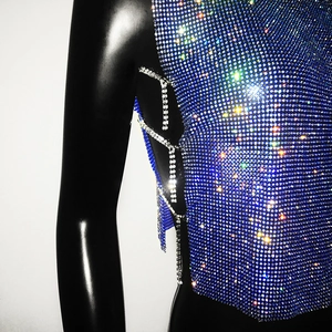 Detail of blue rhinestone mesh top featuring side silver chain tassels and sparkling crystals