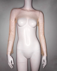 Detail of shimmering gold mesh shrug top with sparkling rhinestones for party wear