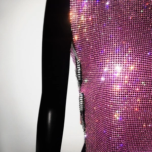 Close-up detail of luxury purple rhinestone mesh top with metallic chain side slit