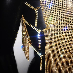 Detail shot of sparkling golden rhinestone mesh top with luxury crystal chain links